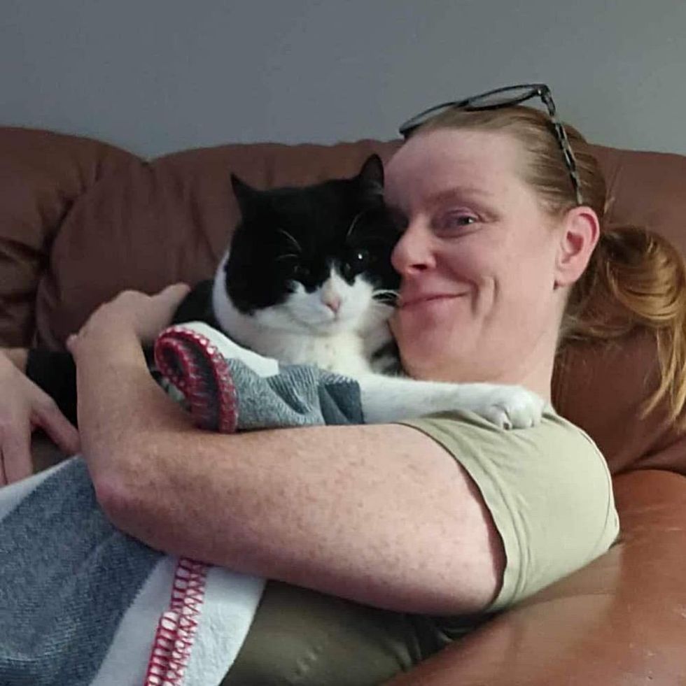 cat cuddling human