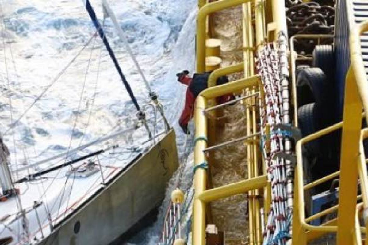 French Sailor Tucks His Cat in His Coat Before Leaping onto Rescue Ship